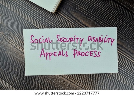 Concept of Social Security Disability Appeals Process write on sticky notes isolated on Wooden Table. Royalty-Free Stock Photo #2220717777