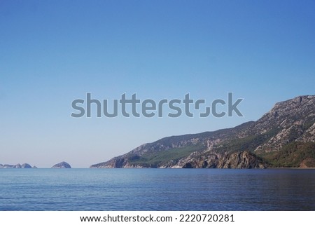 Small rocky Island in the sea. Holidays in Turkey. Sea cruise. Photo on a hot summer day