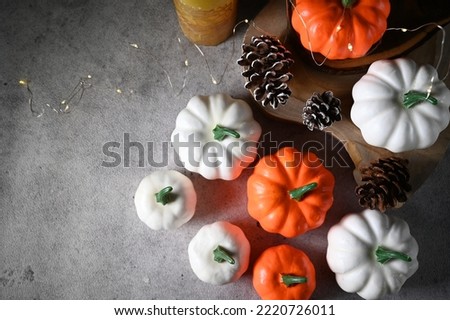 Table decoration pumpkins and pine cones on rustic background, selective focus