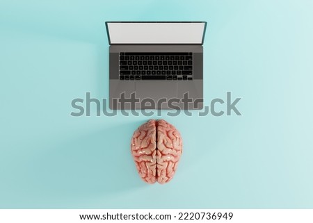 Brain lying in front of the computer on a blue background. Concept of connecting brain to computer, awareness. 3d render.