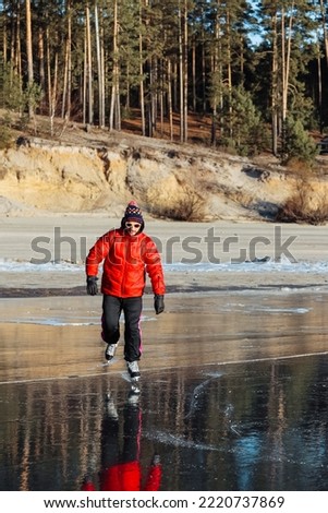 man skating on the lake in the forest