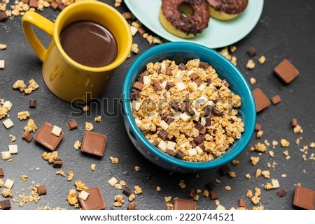 Chocolate granola cereals with chocolate milk and doughnuts