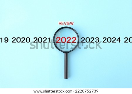 Magnifying glass and 2022 with REVIEW word Royalty-Free Stock Photo #2220752739