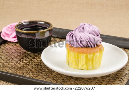 Image of cup cake in white dish on bamboo woven tray