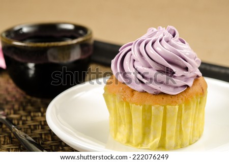 Image of cup cake in white dish on bamboo woven tray