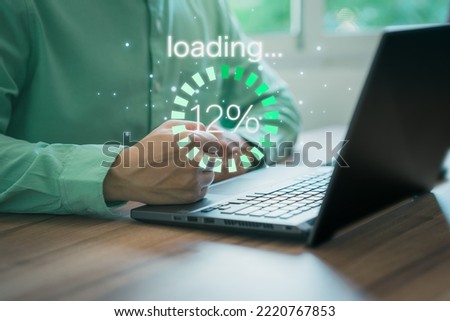 Businessman using a computer laptop to download and waiting to loading digital business data form website, concept of waiting for load of loading bar.