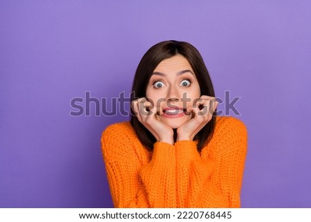 Photo of horrified puzzled girl biting nails stare speechless isolated on violet color background