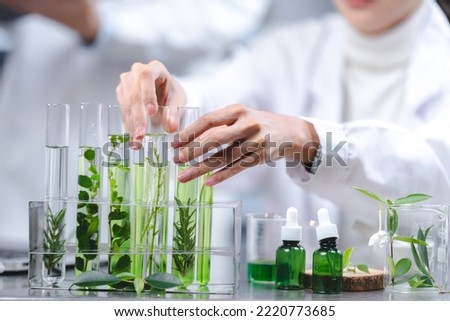 eco skin care beauty products in laboratory development concept, Natural drug research with organic plants and scientific extraction in glassware, Alternative green herb medicine for body health care Royalty-Free Stock Photo #2220773685