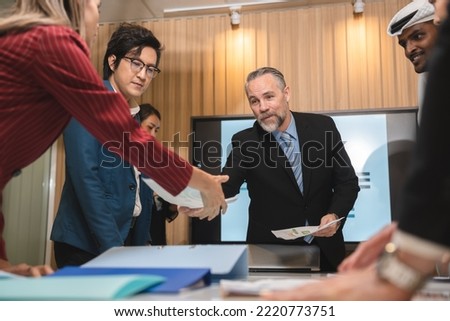 Serious diverse business team leader discuss financial paperwork, Smart businessman and businesswoman partner teamwork talking discussion in group meeting at office table in modern office interior