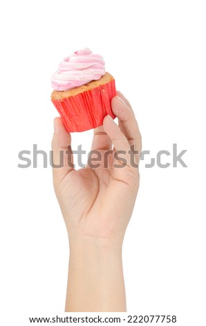 Image of human hand holding cup cake isolate on white background