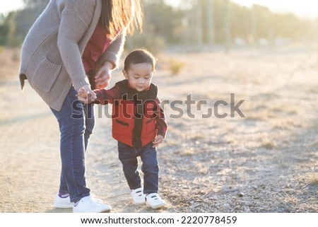 Boy and his mother during sunset