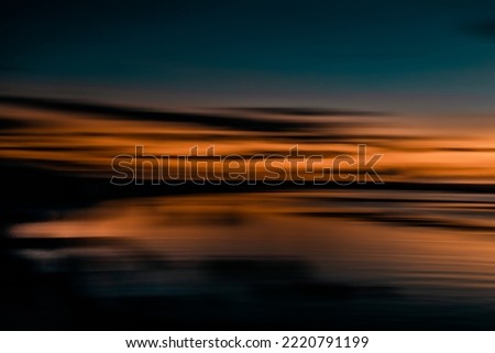 Intentional camera movement in a beach sunset. Horizontal sweep effect. Abstract landscape. Long exposure photography.