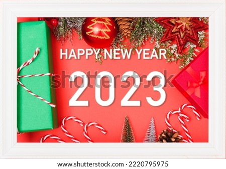 Happy New Year 2023 background. Banner Christmas gifts and decorations with 2023 years number on red background, Flat lay, top view, copy space