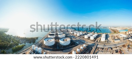 Oil terminal is industrial facility for storage of oil and petrochemical. Business commercial trade fuel energy transport by tanker ship vessel. Aerial Wide panorama view  Royalty-Free Stock Photo #2220801491