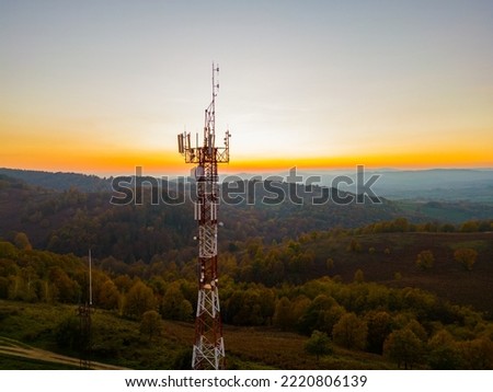 Aerial view of telecommunication tower situated on a hill top, with many cellular antennas which transmits 3G, 4G and 5G signal to phones and other terminals Royalty-Free Stock Photo #2220806139