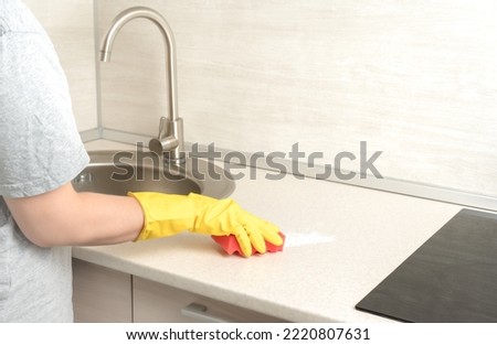 Deep Cleaning service. woman gloves hands cleaning kitchen table. Surface sanitizing. Home cleaning and disinfecting. wearing nitrile gloves. Royalty-Free Stock Photo #2220807631