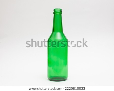 Green glass bottle on white background isolates Royalty-Free Stock Photo #2220810033