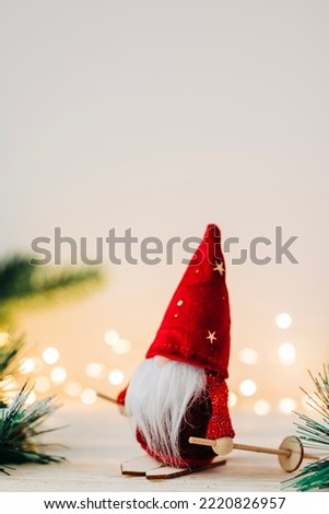 Christmas santa toy decoration closeup image with free copy space for text and festive garland lights