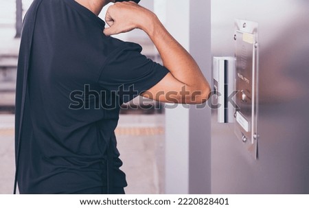 Man passenger using elbow pressing the elevator button,Modern lift panel