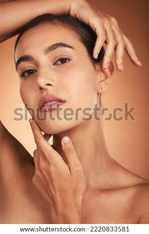 Portrait, skincare and beauty with a model woman touching her face in studio on a beige background. Hands, wellness and luxury with a female posing to promote a natural product or skin treatment