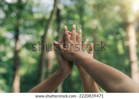 World environment day with global community teamwork, a group of volunteers joining hands together concept. People join for cooperation success. sustainable development goal. teamwork and business Royalty-Free Stock Photo #2220839471