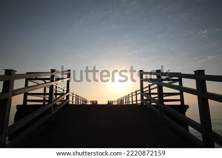 Empty pier at sunrise, low angle view Royalty-Free Stock Photo #2220872159