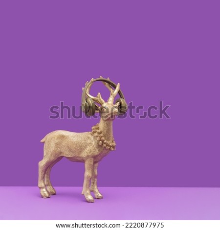 Golden reindeer with headphones on a vibrant purple background. Trendy surreal composition for winter holidays, Christmas and New Year.