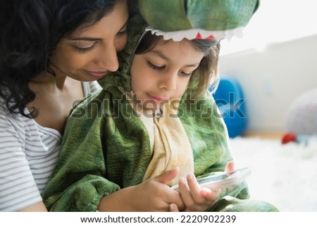 Mother holding son in dragon costume