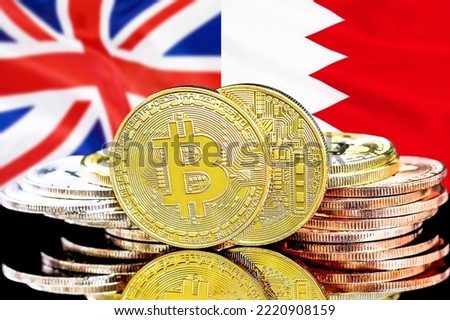 Bitcoins on flag Bahrain and UK background. Concept for investors in cryptocurrency and Blockchain technology in Bahrain and UK