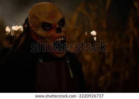 Scary Halloween mask with open mouth in gloomy setting
