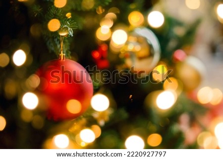 Red and sivlver decoration on Christmas tree at home interior. Holiday background with bokeh lights. Copy space Royalty-Free Stock Photo #2220927797