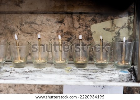 A Hanukkah menorah with glass vials filled with oil and new wicks ready for lighting during the celebration of the Festival of Lights in Israel.