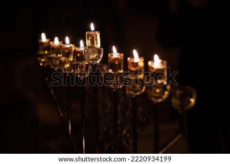 Hanukkah menorah with oil lights burning in Jerusalem during the celebration of the Festival of Lights in Israel. Royalty-Free Stock Photo #2220934199