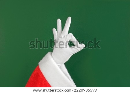 Santa Claus Hands Making Victory Sign and OK Gesture Isolated On Green Background. Close Up. Christmas Congratulation. Chroma Key Screen. Everything is Good. Proposing product. Gestures  Royalty-Free Stock Photo #2220935599