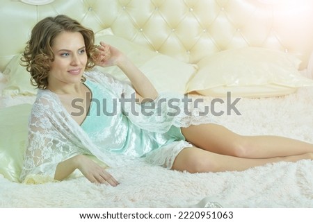 Portrait of young beautiful woman waking up on bed