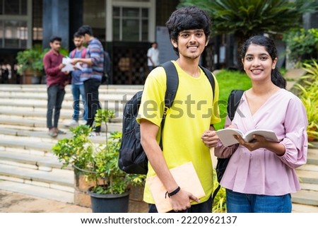 happy smiliung students looking at camera while preparing for exams by reading books at college campus - concept of knowledge, education and competition