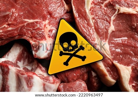 Skull and crossbones sign on raw meat, top view. Be careful - toxic Royalty-Free Stock Photo #2220963497