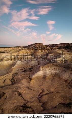Erosional arid features in the Valley of the Moon at sunset. Vertical panoramic view. General Roca, Rio Negro, Argentina Royalty-Free Stock Photo #2220965593