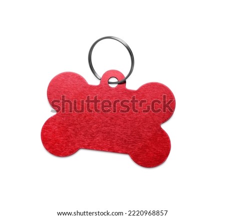 Red metal bone shaped dog tag with ring isolated on white