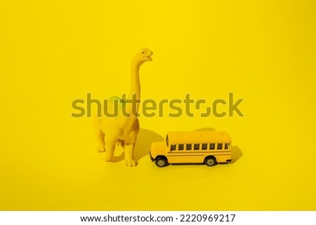 Dinosaurs with school bus on a yellow background. Minimal design.