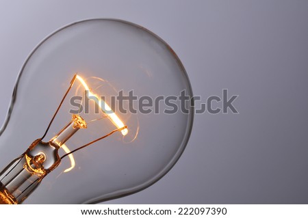 Close up glowing light bulb Royalty-Free Stock Photo #222097390