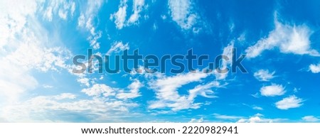 Background with blue sky and white clouds. Narrow panorama.