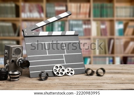 Film concept. Clapperboard and lenses and videotape