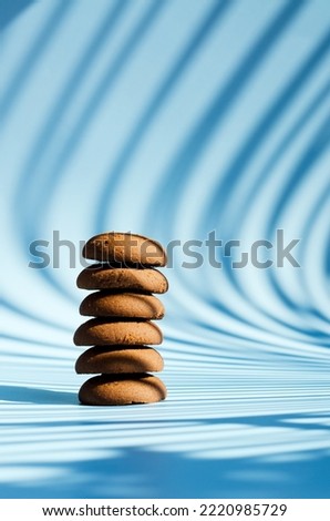 Cup of hot coffee and sweet cookies on blue background. Biscuit,  pastry. Top view, copy space, mockup. Flat lay. Food and drink.