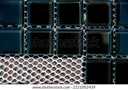 glass black tiles for creativity. Texture of decorative mosaic square tiles on mesh backing close-up