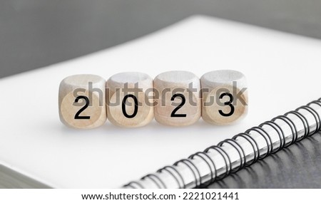 wooden cube with on the wooden table 2023 goal icon, concept to success of growing business.
