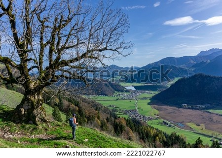 Hiking in Tyrol near Walchsee: The mountains of Zahmer and Wilder Kaiser - View to Walchsee with woman