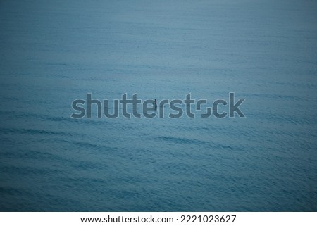 a man floats on a board with an oar on the sea
