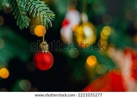 Red and silver decoration on Christmas tree at home interior. Holiday background with bokeh lights. Christmas and New Year background.