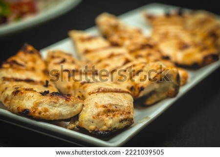 Grilled Chicken Breast Strips marinated in signature Blackened Spice Seasoning Royalty-Free Stock Photo #2221039505